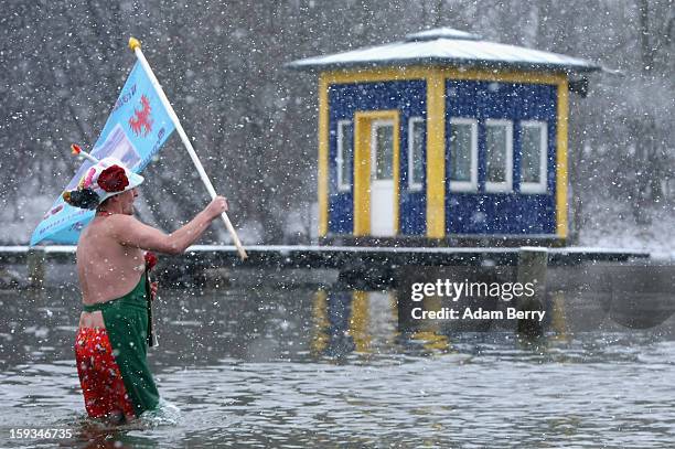 An ice swimming enthusiast enters the cold waters of Orankesee lake during the 'Winter Swimming in Berlin' event on January 12, 2013 in Berlin,...