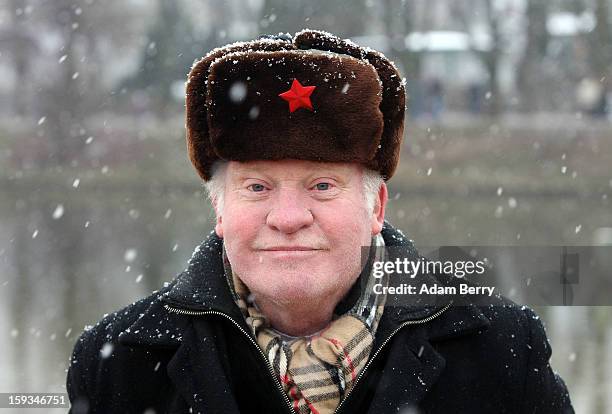 Visitor in a Soviet hat stands near the cold waters of Orankesee lake during the 'Winter Swimming in Berlin' event on January 12, 2013 in Berlin,...