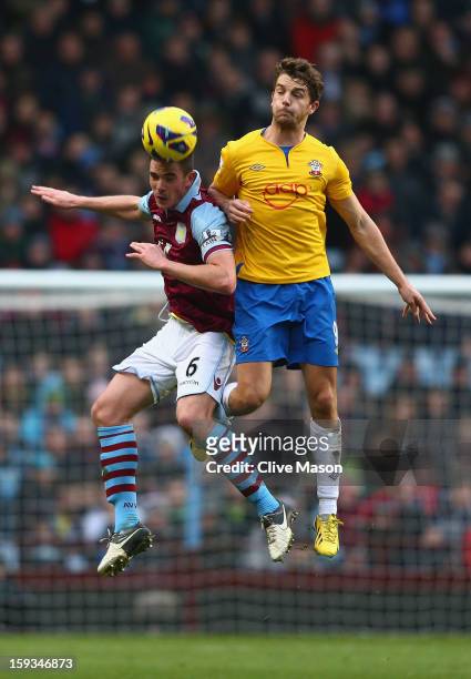 Ciaran Clark of Aston Villa holds off a challenge from Jay Rodriguez of Southampton during the Barclays Premier League match between Aston Villa and...