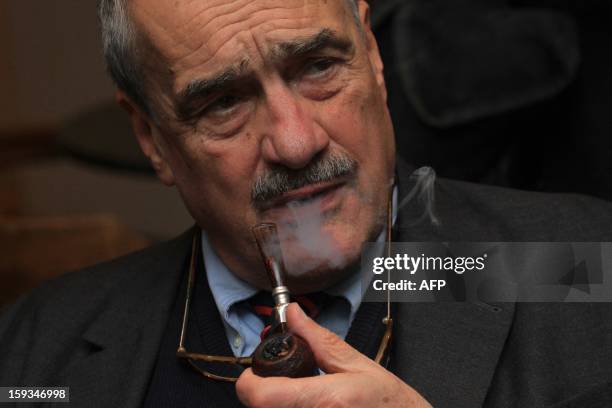 Czech Foreign Minister Karel Schwarzenberg smokes a pipe as he waits for the results of the presidential elections in Prague, on January 12, 2013.The...
