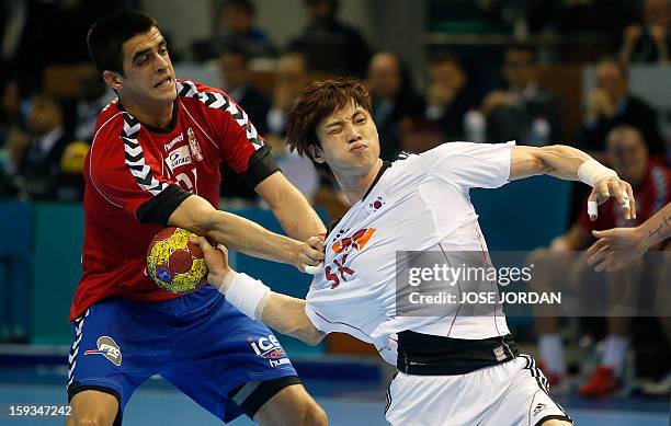 Serbia's centreback Zarko Sesum vies with Korea's back Chan-Yong Park during the 23rd Men's Handball World Championships preliminary round Group C...