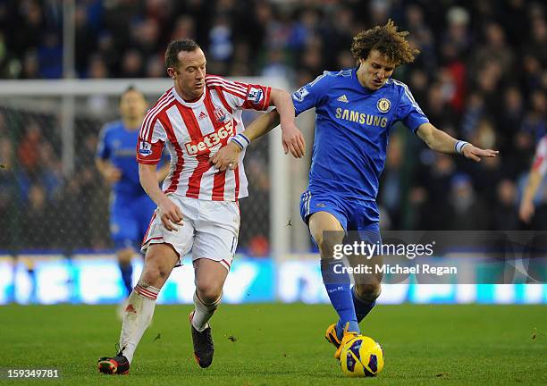 David Luiz of Chelsea competes with Charlie Adam of Stoke City during the Barclays Premier League match between Stoke City and Chelsea at the...