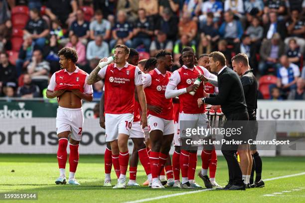 Rotherham United's Hakeem Odoffin takes a drink as he celebrates scoring the opening goal with Manager Matt Taylor close by during the Sky Bet...