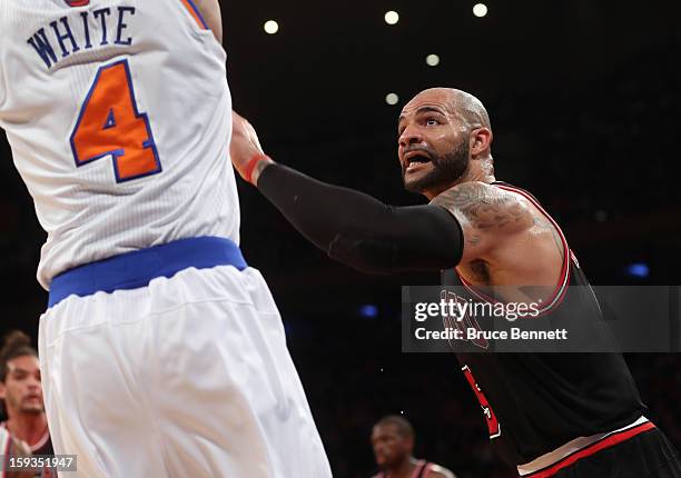 Carlos Boozer of the Chicago Bulls guards against Jason Kidd of the New York Knicks at Madison Square Garden on January 11, 2013 in New York City....