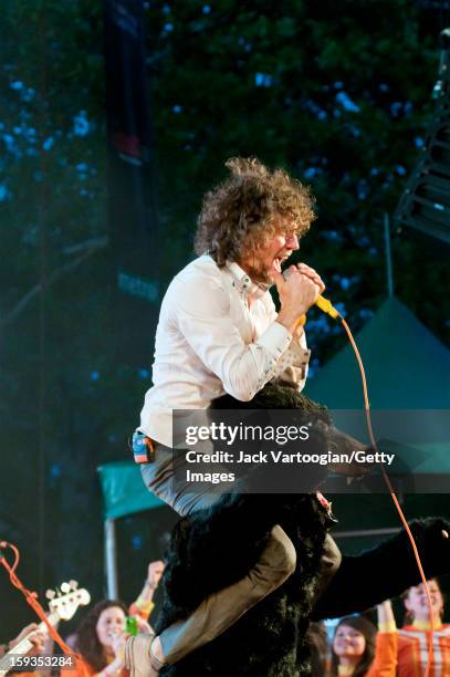 American rock musician Wayne Coyne, of the band the Flaming Lips, performs from atop a stuffed bear at a Benefit on Central Park's SummerStage, New...