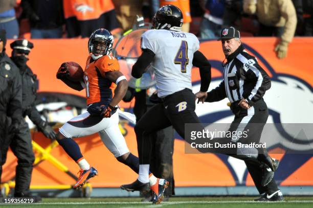 Trindon Holliday of the Denver Broncos returns a punt 90-yards for a touchdown in the first quarter against Sam Koch of the Baltimore Ravens during...