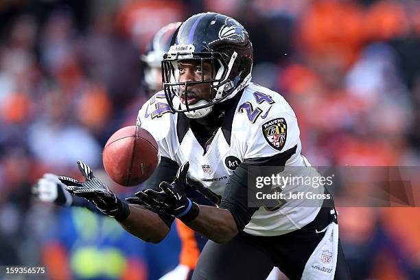 Corey Graham of the Baltimore Ravens intercepts a pass by Peyton Manning of the Denver Broncos which Graham returnd for a 39-yard touchdown in the...