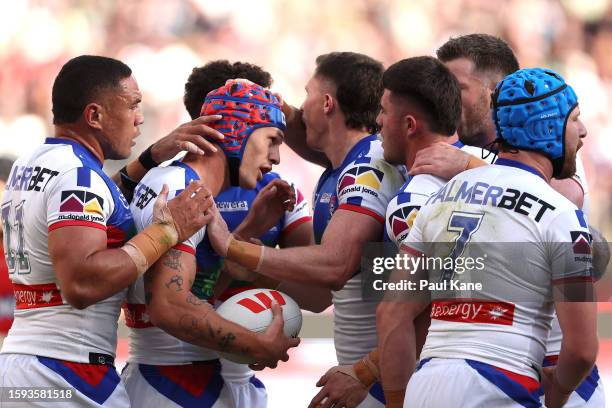 Kalyn Ponga of the Knights celebrates crossing for a try during the round 23 NRL match between Dolphins and Newcastle Knights at Optus Stadium on...