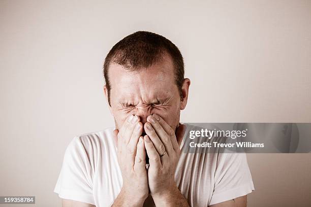 a man just before or after a sneeze - sinus stock-fotos und bilder