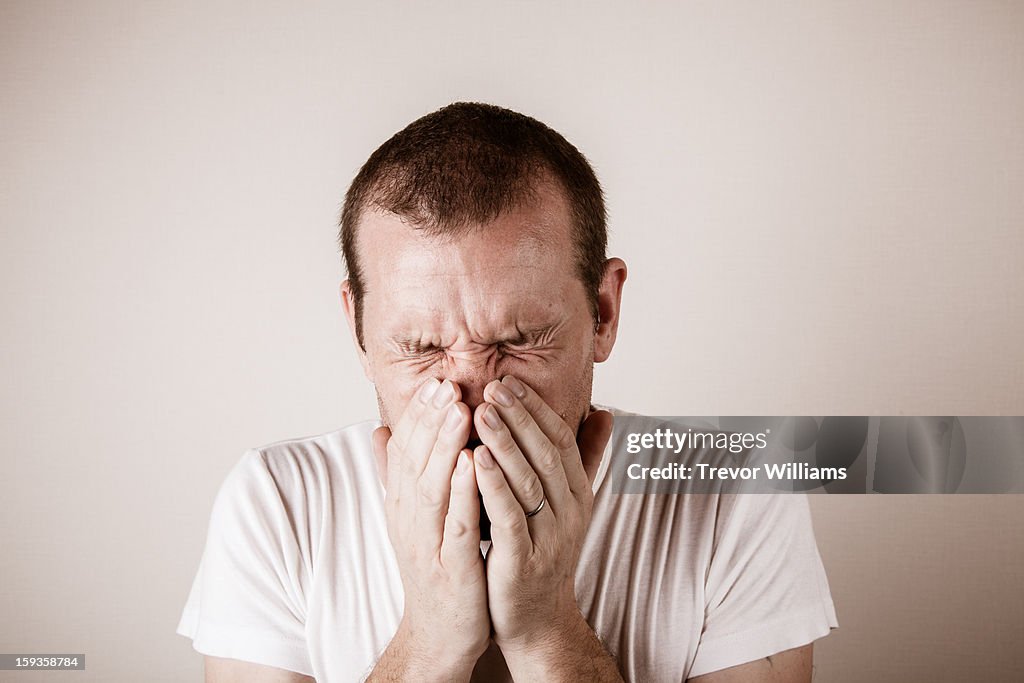 A man just before or after a sneeze