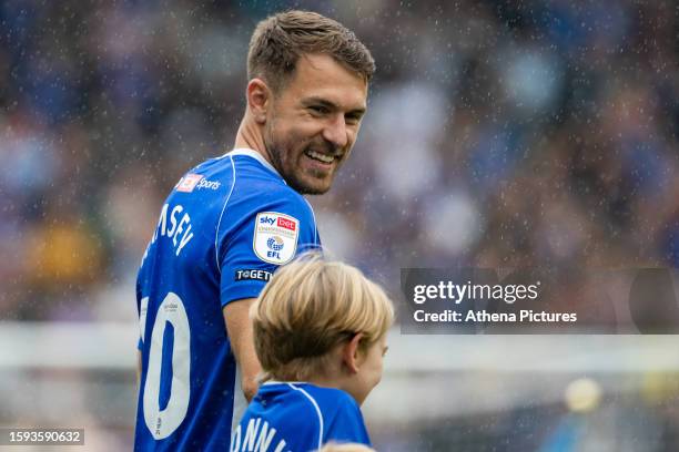 Aaron Ramsey of Cardiff City enters the pitch with his son during the Sky Bet Championship match between Cardiff City and Queens Park Rangers at the...