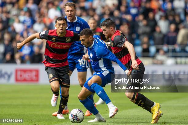 Andre Dozzell and Paul Smyth of Queens Park Rangers challenge Karlan Grant of Cardiff City during the Sky Bet Championship match between Cardiff City...