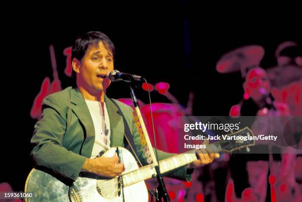 American musician Paul Simon plays guitar during the tour in support of his 'Graceland' album on stage at the Jones Beach Theatre, Wantagh, New York,...