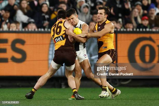 Nick Daicos of the Magpies marks the ball before colliding with James Blanck of the Hawks during the round 21 AFL match between Hawthorn Hawks and...