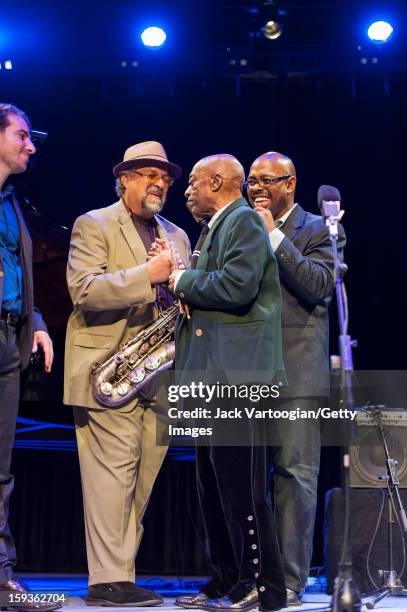 At the conclusion of 'Jazz For Obama 2012: The Jazz Concert For America's Future,' American musicians Joe Lovano and Roy Haynes clasp hands, watched...