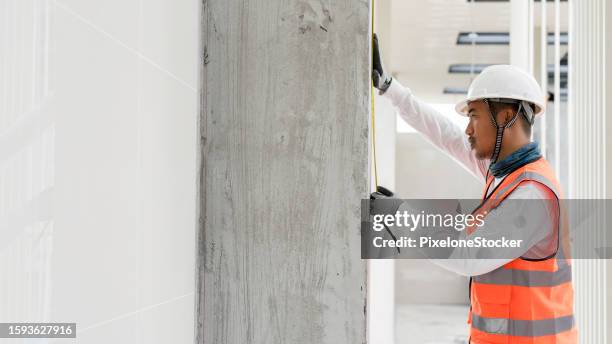 worker doing verify the wall alignment to ensure before further process doing wall tile work. - further stock pictures, royalty-free photos & images