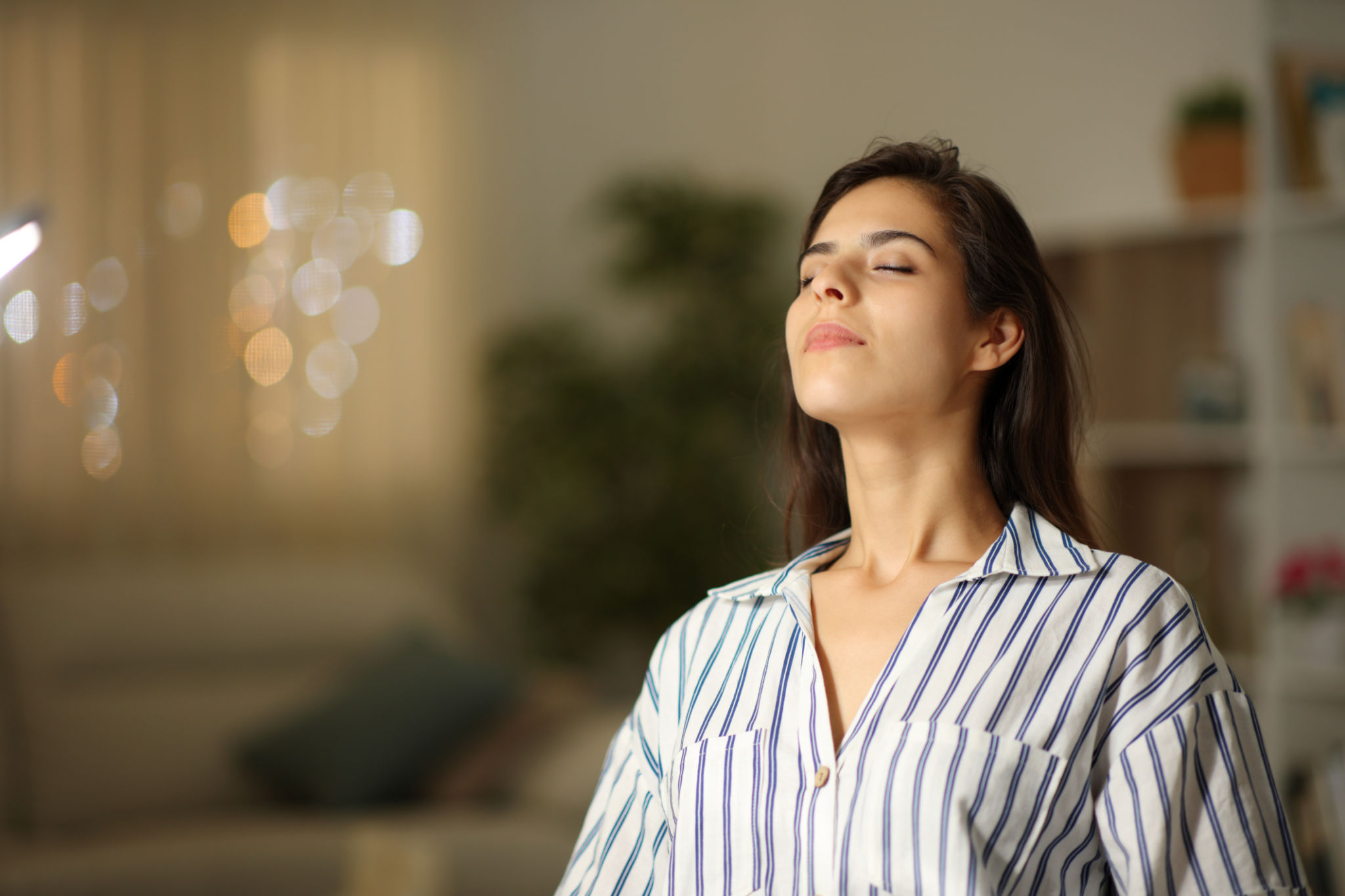 Satisfied woman breathing at home in the night Satisfied woman breathing at home in the night