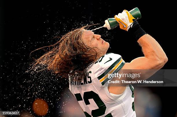 Outside linebacker Clay Matthews of the Green Bay Packers sprays his face with water during warm ups prior to the NFC Divisional Playoff Game against...