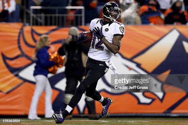 Jacoby Jones of the Baltimore Ravens scores a 70-yard touchdown reception in the fourth quarter to tie the game 35-35 against the Denver Broncos...