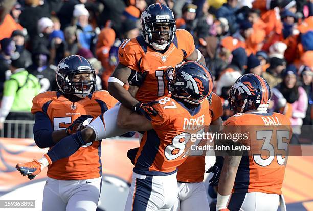 Denver Broncos wide receiver Trindon Holliday celebrates with teammates after scoring a touchdown on an 89 yard punt return early in the first...