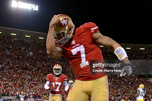 Quarterback Colin Kaepernick of the San Francisco 49ers celebrates after running in a touchdown in the first quarter against the Green Bay Packers...