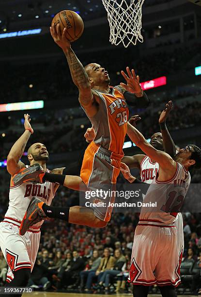 Shannon Brown of the Phoenix Suns puts up a shot over Carlos Boozer, Loul Deng and Kirk Hinrich of the Chicago Bulls at the United Center on January...