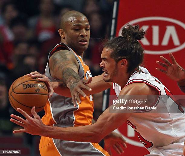 Joakim Noah of the Chicago Bulls is fouled while rebounding by P.J. Tucker of the Phoenix Suns at the United Center on January 12, 2013 in Chicago,...