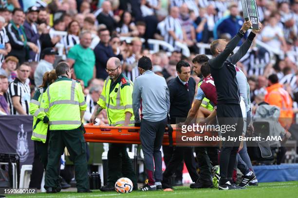 Tyrone Mings of Aston Villa goes off on a stretcher during the Premier League match between Newcastle United and Aston Villa at St. James Park on...