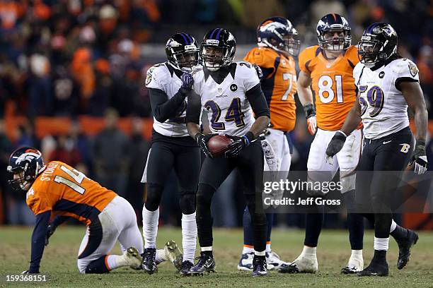 Chykie Brown and Corey Graham of the Baltimore Ravens celebrate after Graham intercepted a pass in overtime against the Denver Broncos during the AFC...