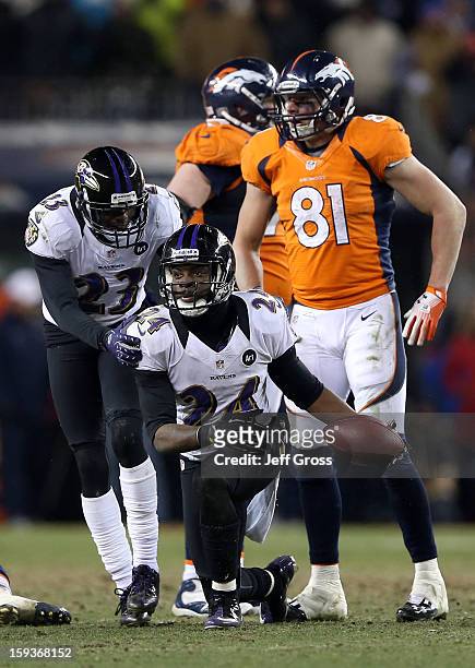 Chykie Brown and Corey Graham of the Baltimore Ravens celebrate after Graham intercepted a pass in overtime against the Denver Broncos during the AFC...