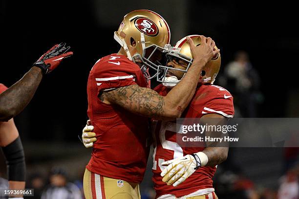 Wide receiver Michael Crabtree of the San Francisco 49ers hugs quarterback Colin Kaepernick after a touchdown in the second quarter against the Green...