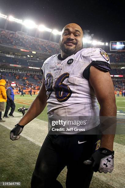 Ma'ake Kemoeatu of the Baltimore Ravens celebrates as he walsk off the field after the Ravens won 38-35 in the second overtime against the Denver...