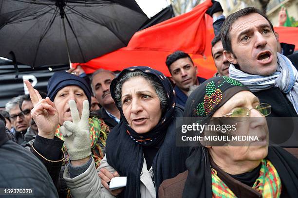 Woman flashes the "V" sign for victory during a demonstration gathering hundreds of people of Kurdish origin, on January 12, 2013 in Paris, two days...