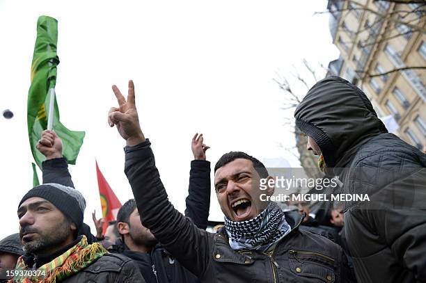 Man flashes a "V" sign for victory during a demonstration gathering hundreds of people of Kurdish origin, on January 12, 2013 in Paris, two days...