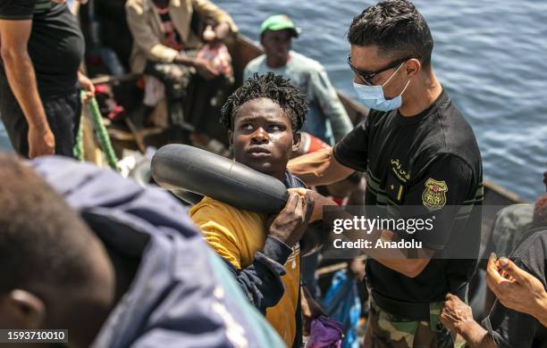 Irregular migrants are seen on the boat as an operation is carried out by the Tunisian National Guard against the migrants who want to reach Europe...