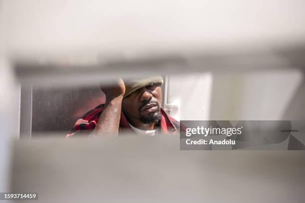Migrant is seen on the boat as an operation is carried out by the Tunisian National Guard against the migrants who want to reach Europe illegally via...