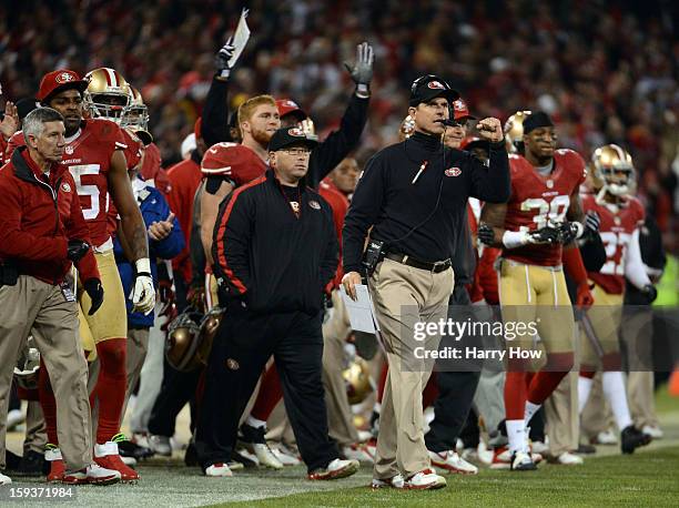 Head coach Jim Harbaugh of the San Francisco 49ers celebrates a field goal at the end of the second quarter against the Green Bay Packers during the...