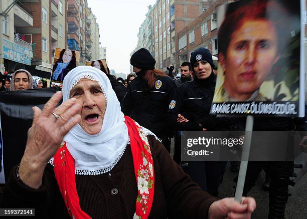 Kurdish woman holds on January 12, 2013 a portrait of the slain founding member of the Kurdistan Workers' Party , Sakine Cansiz, during a protest...