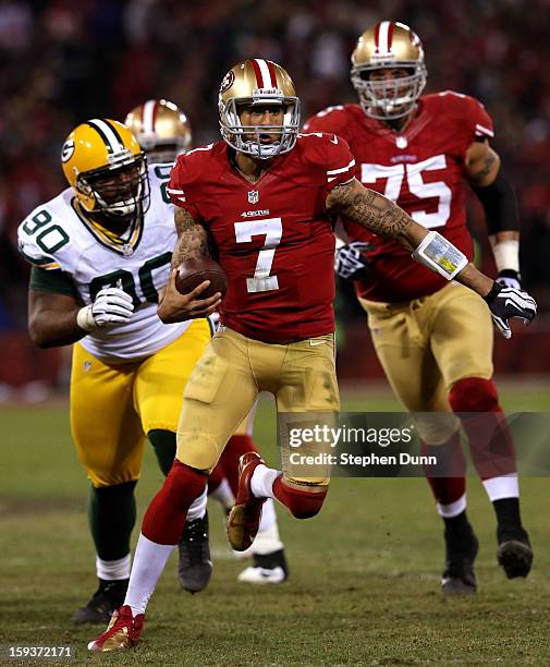 Quarterback Colin Kaepernick of the San Francisco 49ers runs the ball against nose tackle B.J. Raji of the Green Bay Packers during the NFC...