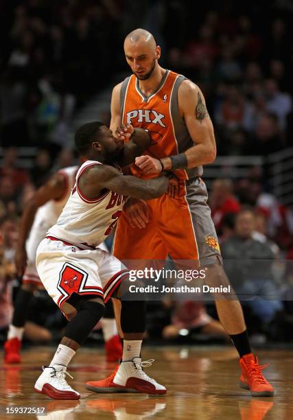 Nate Robinson of the Chicago Bulls tries to move through a screen set by Marcin Gortat of the Phoenix Suns at the United Center on January 12, 2013...