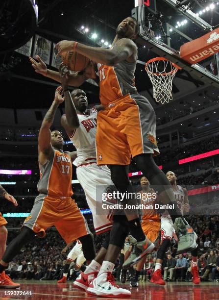 Markieff Morris of the Phoenix Suns slams Loul Deng of the Chicago Bulls at the United Center on January 12, 2013 in Chicago, Illinois. The Suns...