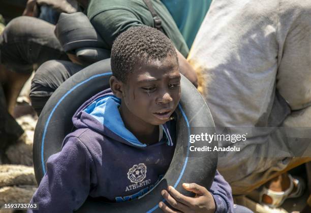 Migrant child cries as an operation is carried out by coastguards teams of the Tunisian National Guard against the migrants who want to reach Europe...