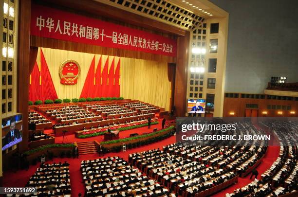 Chinese Premier Wen Jiabao delivers his speech as top leaders of China's ruling Communist party attend the opening session of the National People's...