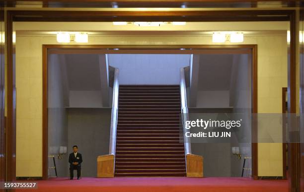 Chinese security guard sits in the Great Hall of the People during a press conference for the Third Session of the 11th National People's Congress in...