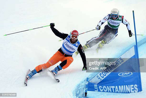 Jean-Frederic Chapuis of France and Scott Kneller of Austria compete during the FIS women's Skicross World Cup on January 12 at the Les Contamines...