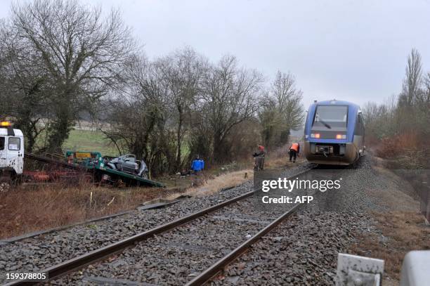 Car destroyed after striking a regional train in a crossing is lifted by a truck on January 12, 2013 in Sarrazac. Three passengers of the car have...