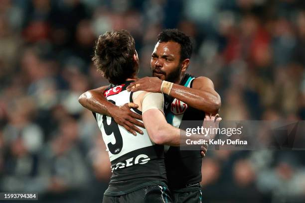 Willie Rioli of the Power celebrates kicking a goal with Zak Butters of the Power during the round 21 AFL match between Geelong Cats and Port...