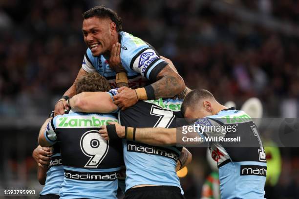 Jesse Ramien of the Sharks jumps on Sione Katoa after a try during the round 23 NRL match between South Sydney Rabbitohs and Cronulla Sharks at Optus...