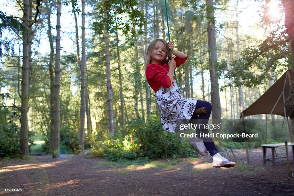 Girl swinging on a tree