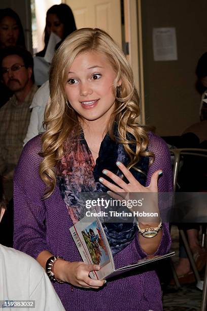 Actress Olivia Holt reads to a group of children at the "Reading With: Marvel Comics Close-Up" kick-off event at the Burbank Public Library on...